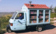 a man sitting in the back of a truck with a book case on it's side