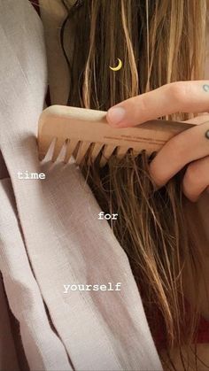 a woman holding a wooden comb in her hand with the words time for yourself written on it