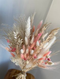 some pink and white flowers are in a vase