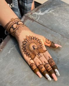 a woman's hand with henna tattoos on it