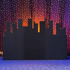 an artistic display in front of a purple and red background with stars on the wall