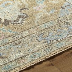 an area rug on the ground with wood flooring and wooden floors in the background