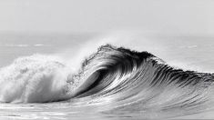 a black and white photo of a wave in the ocean