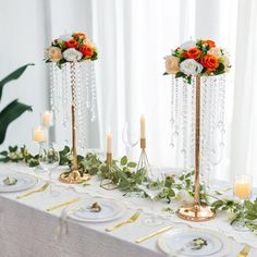 the table is set with candles, plates and flower centerpieces for an elegant wedding reception