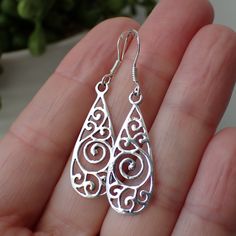 This is a beautiful pair of sterling silver open work swirled teardrop earrings. These earrings are 1.7" long including the ear wire and about .4" wide and come on a sturdy ear wire that will include rubber stoppers. Sterling Silver Teardrop Earrings With Intricate Design, Sterling Silver Intricate Teardrop Earrings, Sterling Silver Filigree Teardrop Earrings, Hypoallergenic Sterling Silver Swirl Earrings, Silver Swirl Pierced Earrings, Swirl Earrings, Gothic Accessories, The Ear, All That Glitters