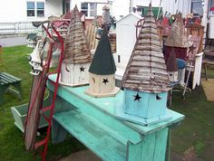 several wooden houses are sitting on top of a bench