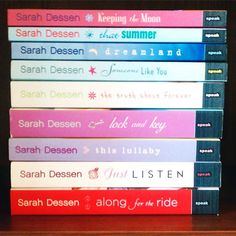 a stack of books sitting on top of a wooden shelf