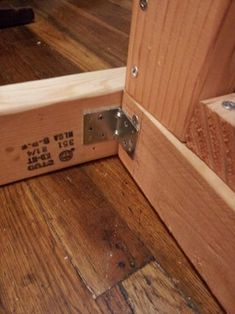 an open wooden door on the inside of a room with hardwood floors and wood flooring