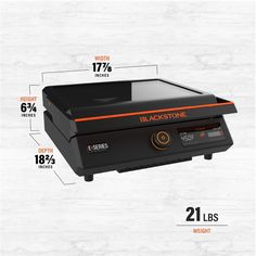 an image of a black stone grill with measurements