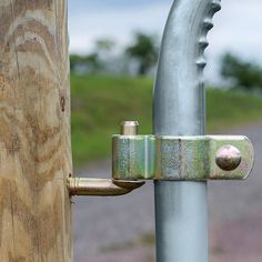 a close up of a metal pole with a lock on it's back end