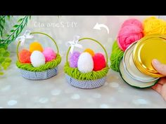 two baskets with balls of yarn in them, one is holding a can and the other has a tin