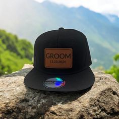 Celebrate the big day with ourGroom Hat with Personalized Wedding Date, designed to commemorate your special moment. This Wedding SnapBack Trucker Hat with a leather patch is the perfect gift idea for the groom or a stylish accessory for bachelor party celebrations. 𝐃𝐄𝐓𝐀𝐈𝐋𝐒  🧢 Custom Engrave Groom Established Year Leather Patch Hat  🧢One Size Fits All  🧢High Quality Hip Hop Style Hat 𝐇𝐎𝐖 𝐓𝐎 𝐎𝐑𝐃𝐄𝐑 1. Enter the Established Year you would like on the Hat in the personalization text box. 2. Add to Cart  3. Select Desired Shipping Method  𝐒𝐇𝐈𝐏𝐏𝐈𝐍𝐆 🧢 Ships in 1-4 business days 𝐘𝐎𝐔 𝐌𝐈𝐆𝐇𝐓 𝐀𝐋𝐒𝐎 𝐋𝐈𝐊𝐄 🧢Personalized Kids Hat https://rockwyncreations.etsy.com/listing/1748646382 🧢Engraved Dad Hat https://rockwyncreations.etsy.com/listing/1769638245 🧢Engrav Personalized Hat For Groom, Groom Hat, Wedding Gifts Ideas, Leather Patch Hat, Novelty Hats, Hat Wedding, Kids Hat, Patch Hat, Snapback Caps