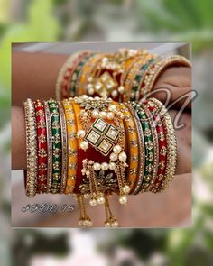 Make A Bold Statement With Stunning Bridal Chura Set Assembled In Three Cute Colors Yellow, Red & Green. Center Piece Prettified With Exclusive Hanging Pearls Chain On Base Of Red & Yellow Color. Metal Figures And Floral Shape Kundan Fitting Is Making This Ensemble Outstanding. Feel The Moment Of Perfect Appreciation In This Exclusive Creation. This is a set of 26 Bangles (13 For Each Hand). Red Bridal Sets For Festive Party, Festive Red Bridal Sets For Party, Red Bridal Sets With Pallu For Diwali, Multicolor Festive Bridal Sets For Wedding, Festive Multicolor Bridal Sets For Wedding, Traditional Red Bridal Sets For Party, Festive Red Bridal Sets For Weddings, Festive Red Bridal Sets, Multicolor Bridal Sets With Pallu For Festive Occasions