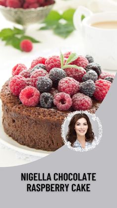 a chocolate raspberry cake with fresh berries on top and the words, nigglela chocolate raspberry cake