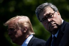 two men standing next to each other in front of trees and one is wearing glasses