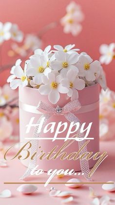 a pink birthday card with white flowers in a box