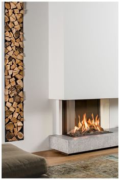 a fire place with logs in the background