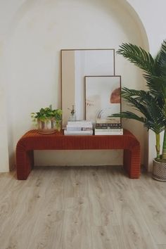 there is a table with books and plants on it