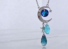 blue-crystal-moon-necklace-wexford-jewelers Mystical Blue Moon Phase Necklace, Elegant Blue Moon Shaped Necklace, Mystical Blue Moon Charm Jewelry, Blue Mystical Necklace With Moon Charm, Adjustable Blue Moon-shaped Jewelry, Blue Mystical Moon Charm Jewelry, Silver Moon-shaped Crystal Necklace With Gemstone, Sterling Silver Moon-shaped Crystal Necklace, Mystical Silver Moon-shaped Crystal Necklace