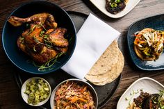 several plates of food on a table with napkins and utensils next to them