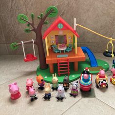 peppa pig plays with his family in the play house and toys on the floor