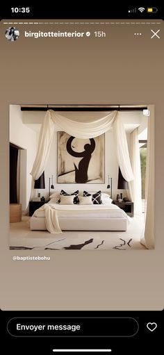 an image of a bedroom with white drapes on the ceiling and artwork above the bed