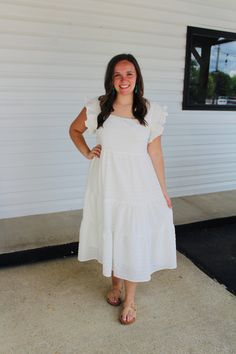 Featuring a square neck, short ruffled sleeves with smocking detail, a tiered silhouette and a textured fabric, this adorable white dress is a must have for summer! Color: White Square neck Short ruffled sleeves with smocking detail Tiered silhouette Midi Length Lined Model is 5'1 and wearing a small. See size guide in images for more details. Measurements are approximate. White Ruffle Hem Tiered Dress For Vacation, White Tiered Dress With Ruffle Hem For Vacation, White Tiered Dress With Ruffles For The Beach, White Tiered Ruffle Dress For Garden Party, White Ruffled Tiered Dress For Garden Party, White Tiered Midi Dress With Ruffles, White Tiered Ruffle Dress For Summer, White Tiered Dress With Ruffle Hem, White Midi Dress With Ruffle Hem And Square Neck