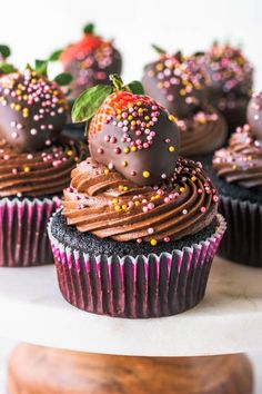 chocolate cupcakes with sprinkles and a strawberry on top