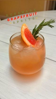 a grapefruit and rosemary garnish cocktail in a glass on a table