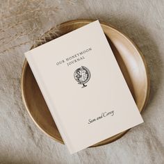 a book sitting on top of a wooden plate