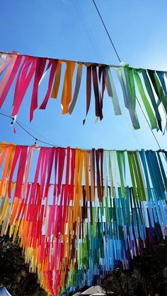 multicolored streamers hanging in the air on a sunny day with blue sky