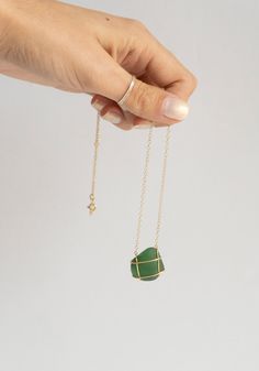 "Caged" Green Sea Glass Necklace handmade by Nathalie Mathoulin in London, United Kingdom. Made from a found piece of sea glass, caged in 18 carat gold on an 18 carat gold chain. Need a second opinion? If you have special requests or just need advice, please reach out to hello@shop-vestige.com. 18k Gold, Sea Glass. Handcrafted in the United Kingdom Seaglass Jewelry, Sea Glass Necklace, Green Sea, London United Kingdom, Sea Glass Jewelry, Glass Necklace, Necklace Handmade, Glass Jewelry, The United Kingdom