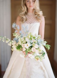 a woman in a wedding dress holding a bouquet