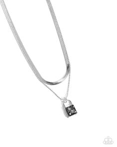 Pressed in a silver padlock pendant, a smoky square gem glistens and glides along a dainty silver ball chain. Layered above the gritty glittery display, a silver herringbone chain creates additional edge and detail. Features an adjustable clasp closure. Sold as one individual necklace. Includes one pair of matching earrings. Elegant Metal Jewelry With Lock Detail, Elegant Metal Jewelry With Lock, Elegant Silver Chain Necklace With Rectangular Pendant, Silver Metal Necklace With Lock Detail, Silver Lock Necklace Gift, Silver Necklace With Lock Gift, Silver Necklace With Lock As Gift, Silver Chain Necklace With Lock, Sterling Silver Lock Necklace