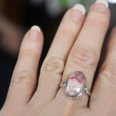 "This ring is made from beautiful genuine Rhodochrosite, and is size 9.  Rhodochrosite is a beautiful natural pink stone with layers of soft and radiant pink, cream and soft taupe.  The oval gemstone is 1/2\" x 3/4\" and is set in sterling silver.  Your sterling silver ring will be shipped gift boxed with a descriptive jewelry card listing gemstones and materials used." Pink Oval Ring With Large Stone, Oval Pink Ring With Large Stone, Pink Oval Spiritual Ring, Pink Opal Rings As A Gift, Pink Natural Stones Ring Jewelry, Bohemian Pink Gemstone Rings, Pink Gemstone Ring With Oval Cabochon, Pink Oval Cabochon Gemstone Ring, Pink Oval Cabochon Opal Ring