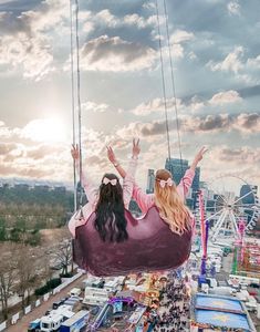 a woman sitting on a swing in front of a ferris wheel