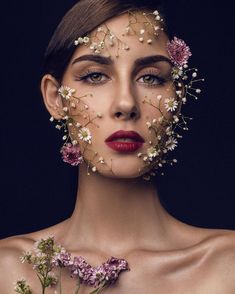 a woman with flowers on her face