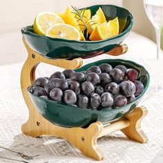 two bowls with fruit in them sitting on a table