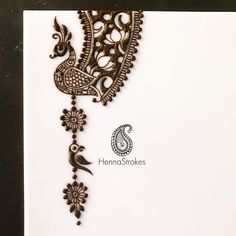 an intricate henna design on a white card