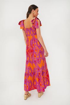 Sheridan French created a line of vibrant, unique pieces that combine handmade prints with flawless design. The collection is undeniably fun, just like the people who wear it.The dress of your dreams, the Exclusive Sunset Ikat Kelly Dress is the encapsulation of easy elegance – and always ensures you will be on the best-dressed list. Versatile enough to wear to a luncheon or wedding alike, the smocked bodice, tie shoulder straps, and flattering fit make this maxi dress one of our must haves. Pai Red Maxi Dress With Abstract Print, Red Maxi Length Dress With Abstract Print, Red Abstract Print Vacation Dress, Red Abstract Print Dress For Vacation, Vibrant Multicolor Abstract Print Dress, Summer Ikat Print Maxi Dress, Vibrant Print Patterned Midi Dress, Patterned Midi Dress With Vibrant Print, Summer Maxi Dress With Ikat Print