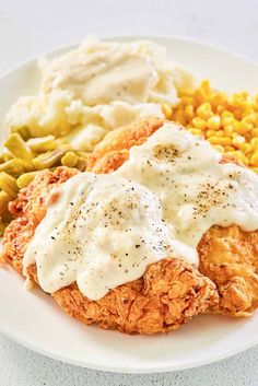 chicken fried in gravy with ranch sauce on top and corn on the side