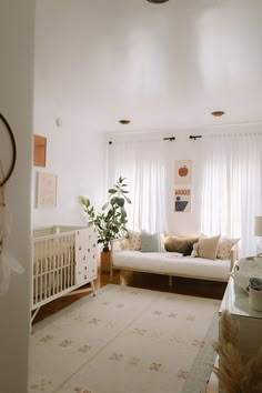 a living room filled with furniture and a baby crib