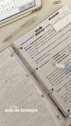 an open notebook sitting on top of a desk next to a keyboard