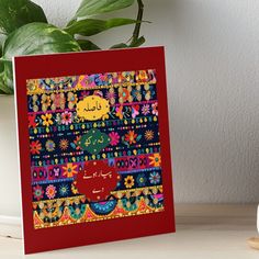 a red card with an image of a cat on the front and colorful designs on the back