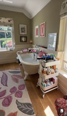 a bath tub sitting next to a window filled with bottles and other items in a bathroom