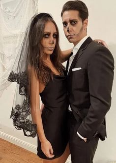 a man and woman dressed up in halloween costumes posing for the camera with makeup on their faces