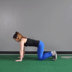 a woman is doing push ups on her knees