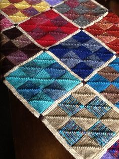 a crocheted table runner with squares in different colors