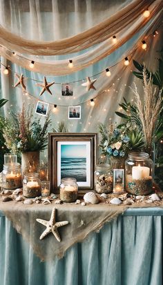 a table topped with pictures and candles next to a starfish hanging from the ceiling