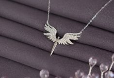 925 Silver Unique Phoenix  Necklace, Guardian Angel Necklace,  Archangel Michael Necklace, 925 Silver Angel Wings Necklace,  Guardian  Angel          Dedtails:     Handmade item       Materials:925 Silver     Style: Minimalist     Made to Order     CARE INSTRUCTIONS :  Our products are made of high quality 925 sterling silver, you can use them for many years if you maintain them regularly. To maintain the quality of your new jewelry, please: -Avoid contact with perfumes, body oils , shampoos, an Elegant Silver Winged Necklace, Elegant Winged Silver Necklace, Winged Sterling Silver Necklace For Gift, Silver Wing-shaped Sterling Silver Necklace, Angel Wings Necklace, Guardian Angel Necklace, Phoenix Necklace, Wings Necklace, Silver Angel Wings